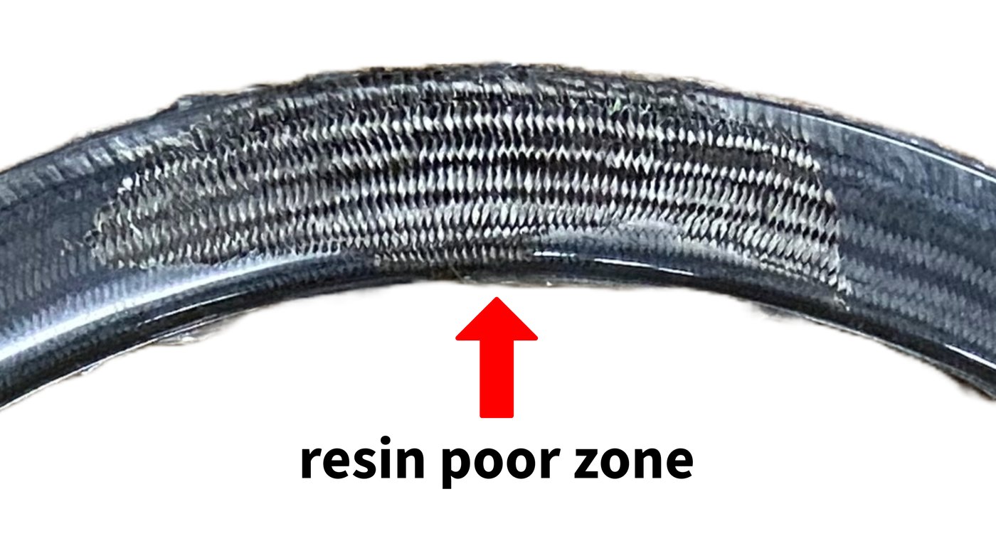 Dry zone on a cured rim where resin failed to fully penetrate the fiber