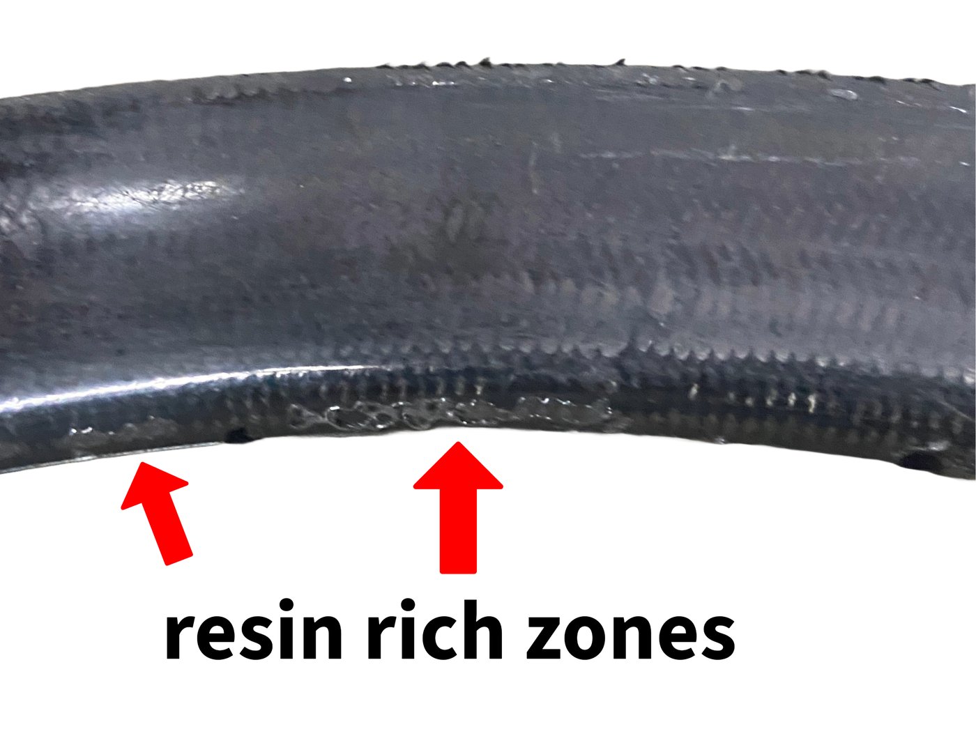 Cured rim surface showing glossy resin-rich pooling along the brake track