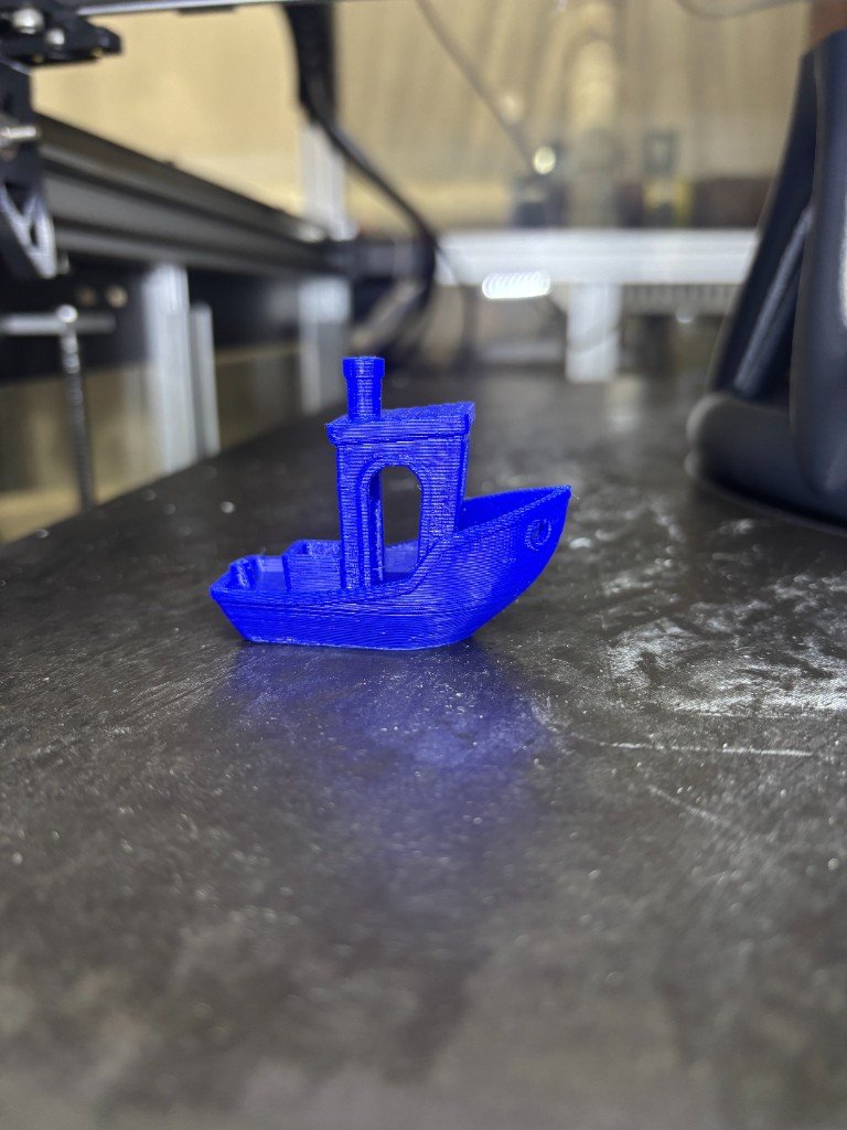 Blue 3DBenchy calibration print on the BlackBot build plate after restoration